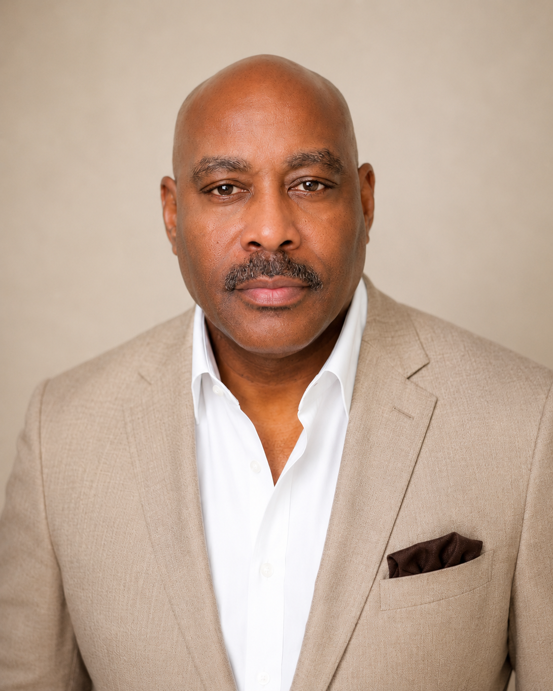 Dr. Melvin Futrell in a tan blazer and white shirt